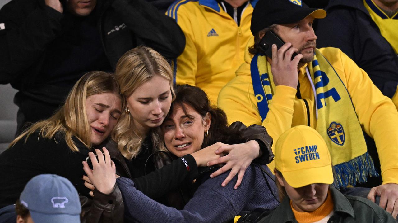 Swedish supporters react as they wait in the stand during the Euro 2024 qualifying football match between Belgium and Sweden at the King Baudouin Stadium in Brussels on October 16, 2023, after an 'attack' that targeted Swedish citizens in a street of Brussels. Belgian federal prosecutor leading on terrorism cases launched an investigation into an attack that left two dead in Brussels on October 16, 2023 evening, a spokesman told AFP. Belgium PM slams Brussels 'attack' targeting Swedish citizens. (Photo by JOHN THYS / AFP)